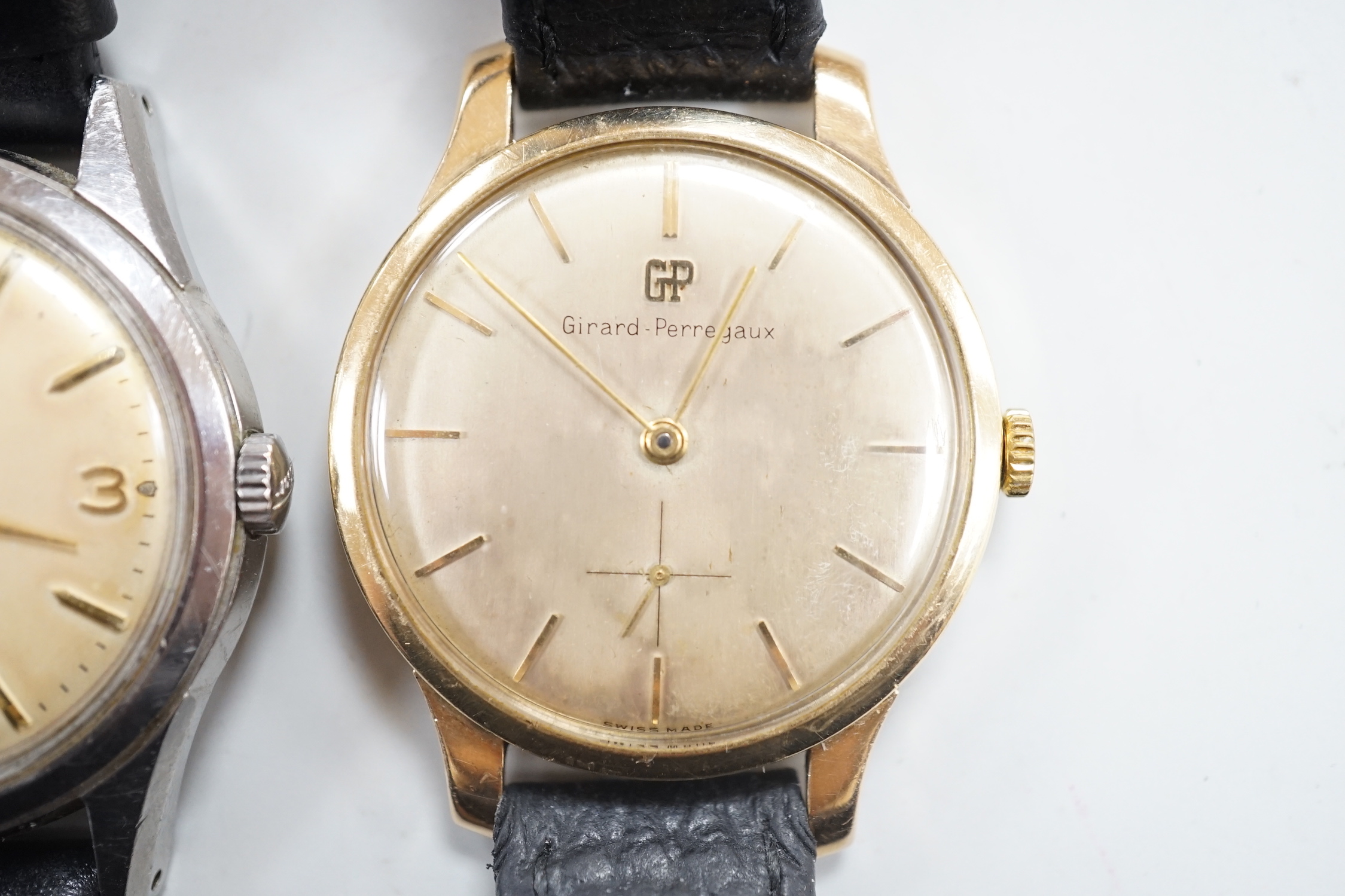 A gentleman's 9ct gold Girard Perregaux manual wind wrist watch, on associated leather strap and a gentleman's stainless steel Tissot Seastar automatic wrist watch.